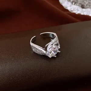 Luxury silver-toned open ring featuring a twisted pavé band and a large central round zircon