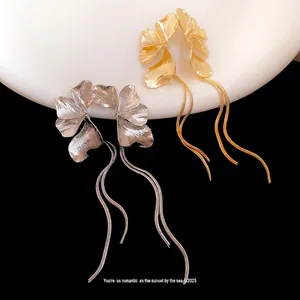 Elegant floral tassel drop earrings with textured gold and silver petals minimalist style
