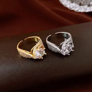 Elegant twisted zircon open ring with sparkling pavé accents in gold and silver