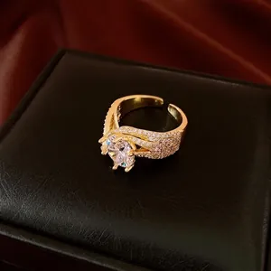 Elegant gold-plated open ring with sparkling zircon and twisted micro-pave details.