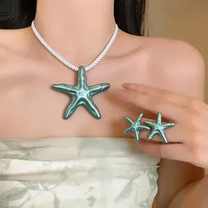 Vue détaillée du collier avec pendentif étoile de mer et de l'ensemble de bijoux assortis.