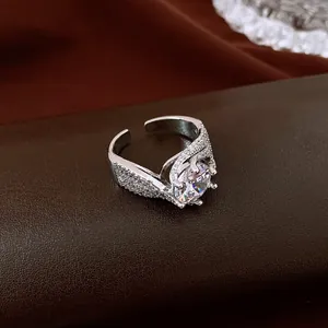 Close-up of a silver-toned open ring featuring a large round zircon and twisted texture