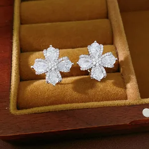 Close-up of elegant zirconia flower ear clips with pear-cut stones and silver-tone finish