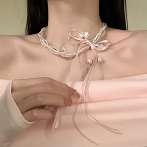 Sweet ballet style necklace with pink ribbon bow and beaded choker strands.