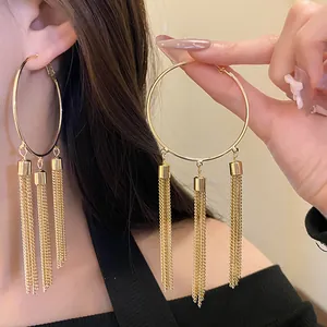 Elegant gold hoop earrings featuring long triple chain tassels for a retro look
