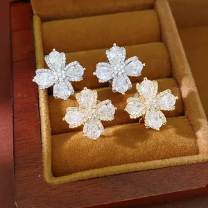 Exquisite close-up of sparkling zircon flower earrings in gold and silver finish