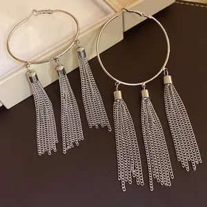 Detailed view of vintage silver hoop earrings featuring triple metal chain tassels