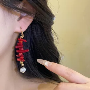 Vintage resin and pearl tassel earrings shown worn with elegant black hair backdrop