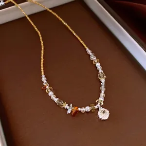 Vintage beaded necklace featuring a sparkling crystal flower pendant and yellow stones