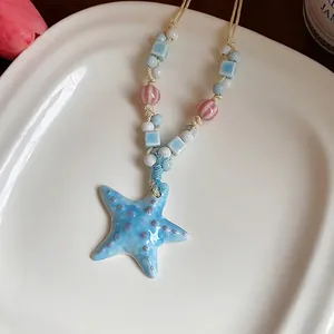 Handmade colorful ceramic starfish pendant necklace with beads on a beige braided cord