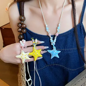 Detail view of colorful ceramic starfish beaded necklaces in dopamine style.