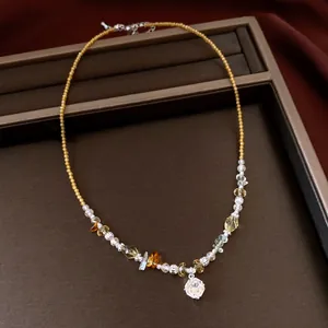 Close-up detail of a vintage beaded necklace featuring a sparkling crystal flower pendant.