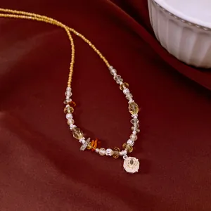Close-up detail of vintage beaded necklace featuring a sparkling crystal flower pendant