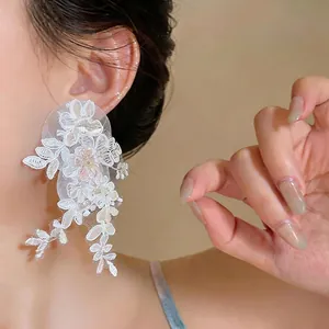 Elegant white lace flower tassel drop earrings worn by a model for a sweet and gentle look