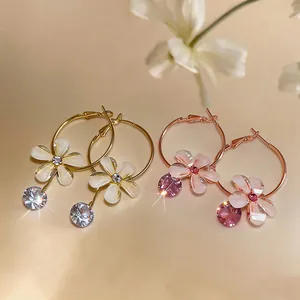 Detailed view of resin flower hoop earrings featuring sparkling round zircon stone dangles.