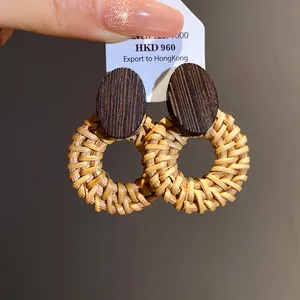 Macro view of retro ethnic wood and rattan woven round hoop earrings with 925 silver studs