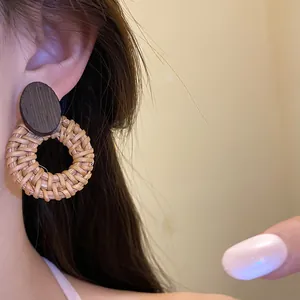 Close-up detail showing the natural wood and woven rattan texture of vintage round earrings