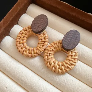 Close-up detail showing the natural texture of rattan and wood on ethnic style earrings