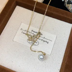 Close-up of 18k gold-plated butterfly necklace with zircon and pearl in a luxury jewelry box