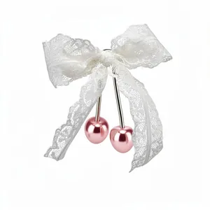 Elegant white lace bow hair clip featuring pink metallic cherry charms for women