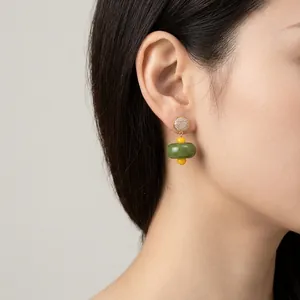 Orecchini vintage in perle di resina con accenti verdi e gialli su orecchio di modella