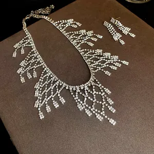 Detailed view of sparkly rhinestone mesh fringe necklace and matching earrings.