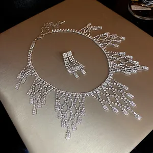 Detailed view of luxury rhinestone necklace and earring set on a gold display stand
