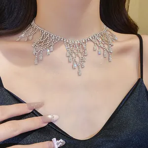 Close-up detail of a glamorous silver rhinestone tassel choker necklace on a model