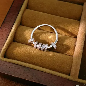 Macro view showing the detailed texture of silver ring with five spinning zircon beads
