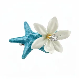 Summer beach hair clip featuring blue starfish and white flower with water drop details