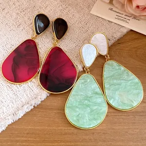 Vintage resin teardrop earrings in burgundy and mint green with elegant gold trim details