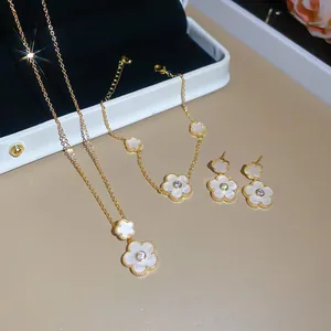 Elegant gold-plated flower jewelry set featuring sparkling zircons and white petals