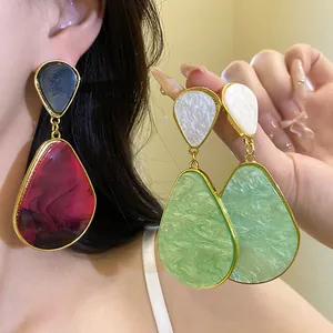 Detailed view of vintage resin water drop earrings with an elegant gold trim finish