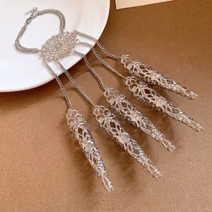 Silver hollow finger claw hand chain with intricate bohemian filigree patterns