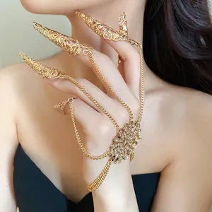 Ornate gold hollow out finger armor ring bracelet with intricate filigree pattern