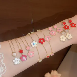 Detail view of gold-plated zircon flower jewelry set featuring colorful enamel petals.