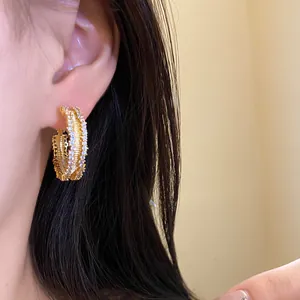 Close-up of elegant 18K gold plated hoop earring with sparkling pavé zircons