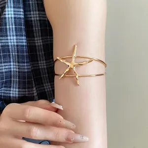 Gold metal starfish open bangle bracelet for a retro minimalist look