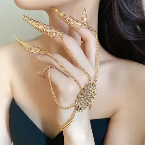 Detailed close-up view of an ornate gold hollow finger claw slave bracelet worn by a model