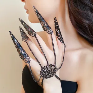 Close-up of black gothic hollow-out finger claw rings with connected hand chain
