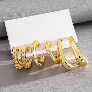 Detailed macro view of six-piece gold C-shaped geometric hoop earrings on display card