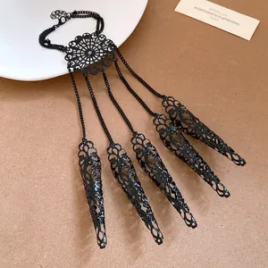 Gothic style black filigree finger armor hand harness with an intricate hollow design