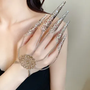 Detailed view of a silver gothic hollow finger claw bracelet with intricate filigree chains