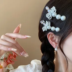 Close-up detail of exquisite rhinestone bow pearl duckbill hair clips and matching earrings on model