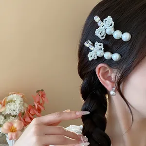 Close-up detail of elegant pearl bow hair clips with rhinestones on a braided hairstyle