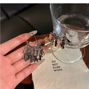Detail view of silver metallic square tassel drop earrings with a polished hook design.