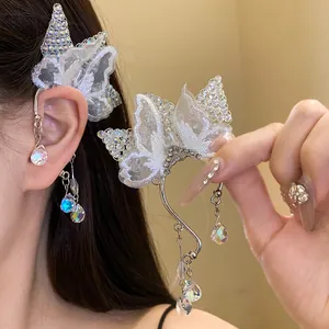 Detailed macro view of exquisite butterfly lace ear cuff with shimmering crystal drop pendants