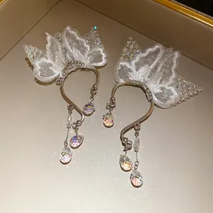 Detailed view of elegant butterfly lace ear cuffs featuring iridescent crystal drops