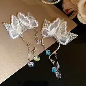Exquisite detail of lace butterfly ear cuffs featuring shimmering iridescent crystal drops