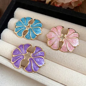 Retro enamel flower stud earrings with gold trim in blue, pink, and purple shades.